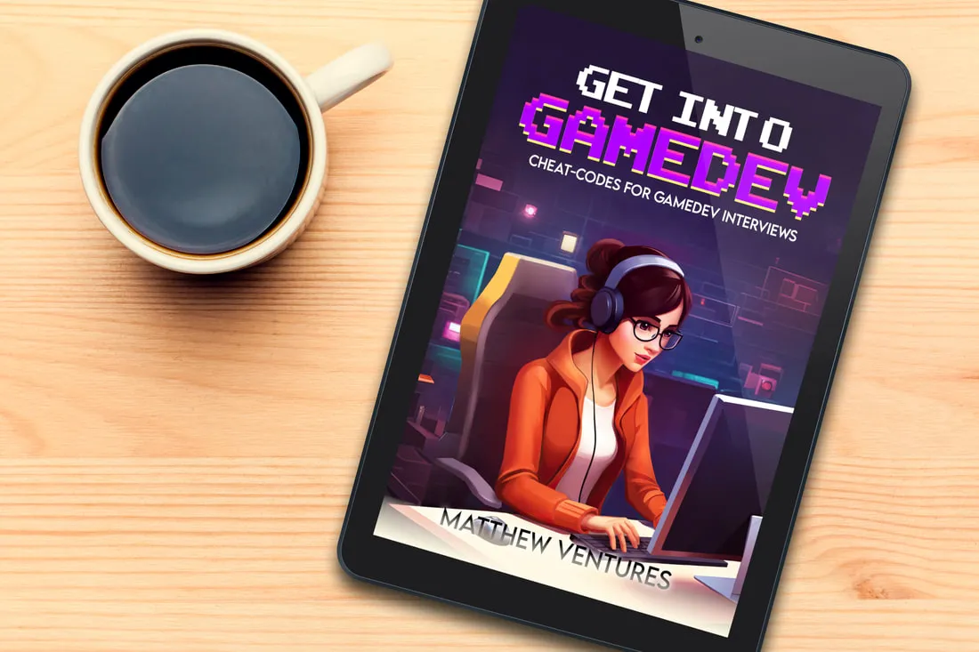 Get Into Game Dev book on a tablet next to a cup of coffee
